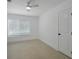 This is a simple bedroom with tiled floors, a ceiling fan and window at 27385 Voyageur Dr, Punta Gorda, FL 33983
