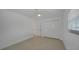 A bright bedroom with a ceiling fan, two closets and white walls at 27385 Voyageur Dr, Punta Gorda, FL 33983
