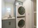 Efficient laundry room with stacked washer/dryer and neutral walls at 27385 Voyageur Dr, Punta Gorda, FL 33983