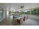 Light-filled sunroom with tiled floors and glass windows overlooking the canal at 27385 Voyageur Dr, Punta Gorda, FL 33983