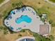 Aerial view of the community pool, highlighting its size and layout, surrounded by palm trees at 2871 Suncoast Lakes Blvd, Punta Gorda, FL 33980