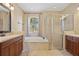 Bathroom featuring a soaking tub, glass-enclosed shower, and double vanity at 2871 Suncoast Lakes Blvd, Punta Gorda, FL 33980