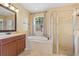 Bright bathroom with a soaking tub, glass shower, and vanity with framed mirror at 2871 Suncoast Lakes Blvd, Punta Gorda, FL 33980
