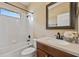 Well-lit bathroom featuring a shower-tub combination, and a modern vanity and mirror at 2871 Suncoast Lakes Blvd, Punta Gorda, FL 33980