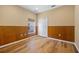 Empty bedroom featuring wood floors, a double closet, a window and base molding at 2871 Suncoast Lakes Blvd, Punta Gorda, FL 33980