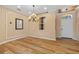 Elegant entryway featuring hardwood floors, chandelier, wainscoting, and a bright window at 2871 Suncoast Lakes Blvd, Punta Gorda, FL 33980