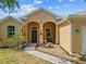 The house's front exterior showing the entryway, some landscaping, and a sidewalk at 2871 Suncoast Lakes Blvd, Punta Gorda, FL 33980