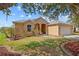 Charming single-story home with a well-manicured lawn and arched entryway at 2871 Suncoast Lakes Blvd, Punta Gorda, FL 33980