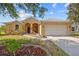 Front exterior of home with a two-car garage, sidewalk, and front lawn at 2871 Suncoast Lakes Blvd, Punta Gorda, FL 33980