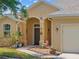 Inviting home entrance with decorative plants, arched entryway, and covered porch at 2871 Suncoast Lakes Blvd, Punta Gorda, FL 33980