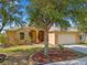 Charming single-story home with a well-manicured lawn, mature tree, and inviting curb appeal at 2871 Suncoast Lakes Blvd, Punta Gorda, FL 33980