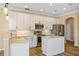 Well-lit kitchen with white cabinets, stainless steel appliances, and center island at 2871 Suncoast Lakes Blvd, Punta Gorda, FL 33980