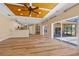 Open living space with wood floors flowing into the kitchen with backyard water views at 2871 Suncoast Lakes Blvd, Punta Gorda, FL 33980