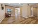Spacious living room featuring beautiful hardwood floors, archway, and scenic views at 2871 Suncoast Lakes Blvd, Punta Gorda, FL 33980