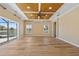 Spacious living room featuring wood floors, fan and slider to a backyard water view at 2871 Suncoast Lakes Blvd, Punta Gorda, FL 33980