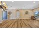 Spacious living room with hardwood floors, wall decor, and a scenic outdoor view at 2871 Suncoast Lakes Blvd, Punta Gorda, FL 33980
