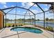 Screened-in pool overlooking tranquil waterfront views at 2871 Suncoast Lakes Blvd, Punta Gorda, FL 33980
