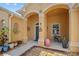 Inviting front porch with seating area and decorative potted plants at 2871 Suncoast Lakes Blvd, Punta Gorda, FL 33980