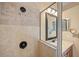 Close-up of tile shower with bronze fixture and tiled wall niche at 2871 Suncoast Lakes Blvd, Punta Gorda, FL 33980