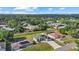 An aerial neighborhood view showcasing a community with houses surrounded by lush greenery and waterways at 3544 Monfero Ave, North Port, FL 34286