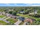 An aerial view showcases the home's roof, solar panels, neighborhood, and surrounding lush landscape at 3544 Monfero Ave, North Port, FL 34286
