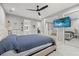Bright bedroom featuring a comfortable bed, mirrored closet, and a television with a beach scene at 3544 Monfero Ave, North Port, FL 34286
