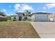 Charming home features a spacious two-car garage and a dry lawn at 3544 Monfero Ave, North Port, FL 34286
