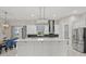 The gourmet kitchen features white cabinets, a large island with a marble countertop, and stainless steel appliances at 3544 Monfero Ave, North Port, FL 34286