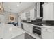 A spacious kitchen with white cabinets, stainless steel appliances, and a large island with marble countertop at 3544 Monfero Ave, North Port, FL 34286