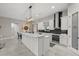 A kitchen with a large island, stainless steel appliances, a pantry and stylish black subway tile at 3544 Monfero Ave, North Port, FL 34286