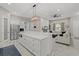 An open living space with kitchen island and large sofa with a fireplace and a wall-mounted TV at 3544 Monfero Ave, North Port, FL 34286