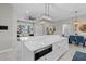 The open concept living space features a kitchen island and living room area with neutral color palettes at 3544 Monfero Ave, North Port, FL 34286