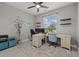 Bright home office with modern ceiling fan, custom shelving, and beautiful backyard views at 3544 Monfero Ave, North Port, FL 34286