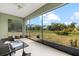 Enclosed patio with glass table offers views of the expansive backyard and lush greenery at 3544 Monfero Ave, North Port, FL 34286