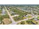 Extensive aerial shot of the community, showcasing the surrounding landscape and nearby pond at 3927 Vasco St, Punta Gorda, FL 33950