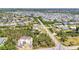 Aerial view of a neighborhood with construction, landscaping, and roadways, showcasing homes in a developing community at 3927 Vasco St, Punta Gorda, FL 33950
