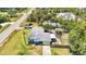 Aerial view of a single-Gathering home with mature palm trees, grassy lawn, and elongated driveway. A construction site is nearby at 3927 Vasco St, Punta Gorda, FL 33950