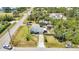 An aerial view of a quaint single-Gathering home with a lengthy driveway surrounded by lush landscaping and a nearby waterway at 3927 Vasco St, Punta Gorda, FL 33950