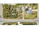 An aerial view shows property boundaries, nearby landscaping and roadways, as well as a single Gathering home at 3927 Vasco St, Punta Gorda, FL 33950