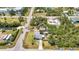 An aerial view of a quaint single-Gathering home with a long driveway surrounded by lush landscaping and a nearby waterway at 3927 Vasco St, Punta Gorda, FL 33950