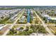 An aerial view shows a residential neighborhood with homes lining canals, interspersed with landscaping and roadways at 3927 Vasco St, Punta Gorda, FL 33950
