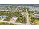 Aerial view of a neighborhood with canals, landscaping, roadways, and a construction site, showcasing homes in a vibrant community at 3927 Vasco St, Punta Gorda, FL 33950