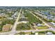 An elevated aerial view of the community with mature trees, neighborhood roads, and canals at 3927 Vasco St, Punta Gorda, FL 33950