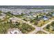 Aerial view of a neighborhood with canals, landscaping, and roadways, showcasing homes near a central waterway and community at 3927 Vasco St, Punta Gorda, FL 33950