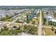 An aerial view showing a residential neighborhood with water canals with homes and waterways that intertwine with roadways and greenery at 3927 Vasco St, Punta Gorda, FL 33950