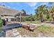 View of a spacious backyard with a covered patio, wooden pergola and lush landscaping, offering a great outdoor living space at 3927 Vasco St, Punta Gorda, FL 33950