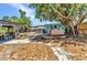Outdoor space featuring multiple lounge areas with an outdoor kitchen, a wooden pergola and a jacuzzi at 3927 Vasco St, Punta Gorda, FL 33950