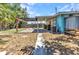 This backyard showcases a covered deck, a wooden pergola and an outdoor shower, creating a unique outdoor retreat at 3927 Vasco St, Punta Gorda, FL 33950