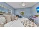 Cozy blue bedroom with natural light from two windows and queen sized bed at 3927 Vasco St, Punta Gorda, FL 33950