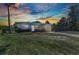 Charming single-story home featuring colorful exterior, well-manicured lawn, and mature trees at 3927 Vasco St, Punta Gorda, FL 33950